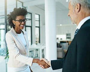 Man and woman shaking hands.