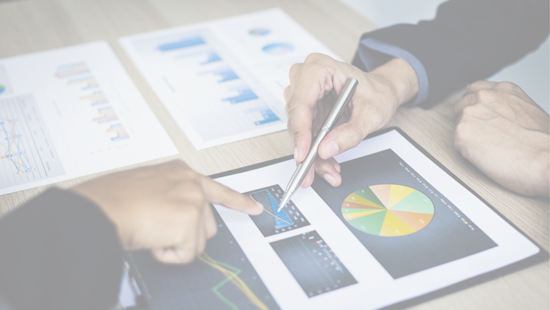 Men pointing to chart on presentation.